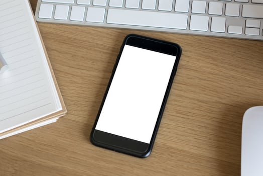 woman hands holding empty screen of smartphone on wood desk work photo