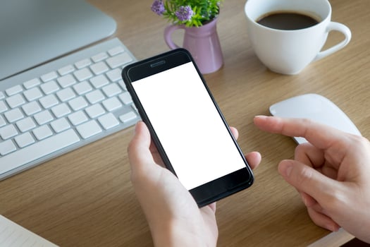 woman hands holding empty screen of smartphone on wood desk work photo