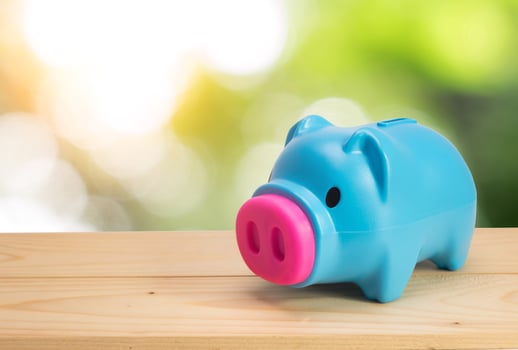 Blue piggy bank on wooden table. saving,money concept. photo
