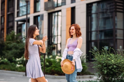 Two beautiful women talking and standing outdoors photo
