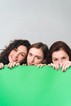 Three beautiful young girls posing for the camera photo