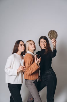 Three beautiful young girls posing for the camera photo