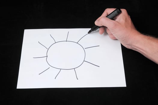 Hand drawing a simple sun photo
