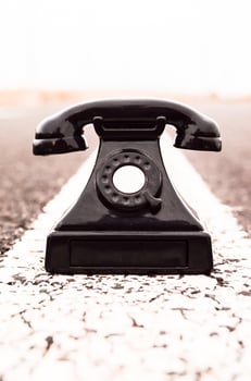 Old telephone on the road photo
