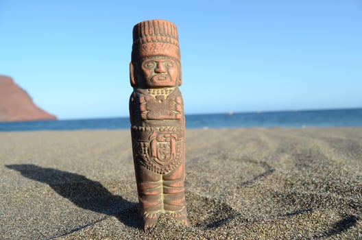 Small Mesoamerican statue at the beach photo
