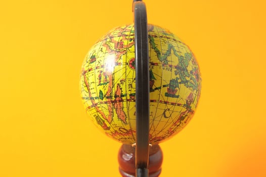 Globe on yellow background photo