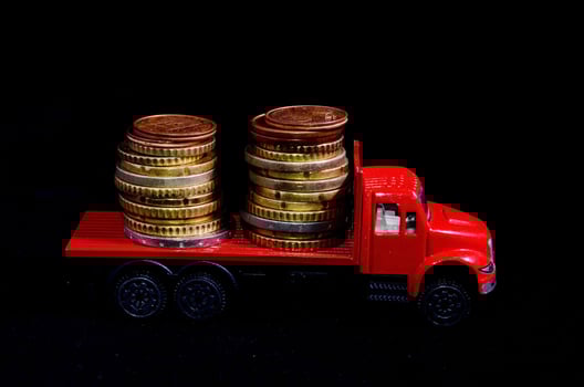 Red toy truck with coins photo