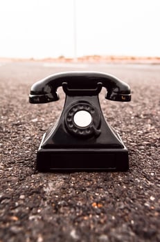 Old telephone on the road photo