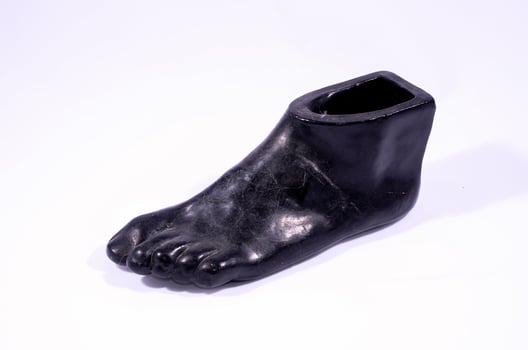 Foot sculpture on white background photo