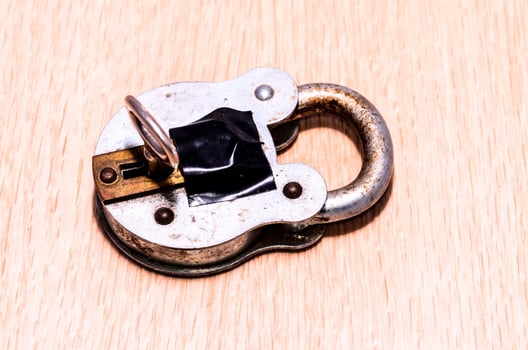 Padlock on wooden background photo