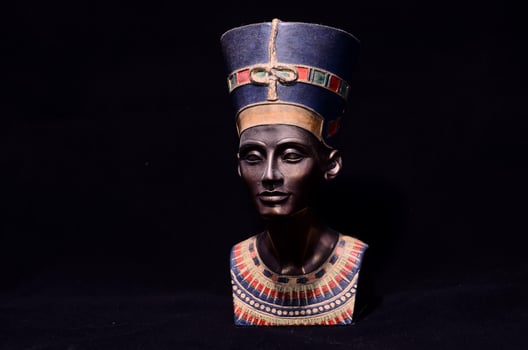 Nefertiti miniature on black background photo
