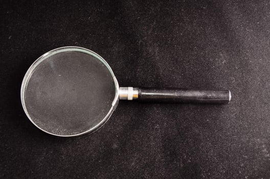 Magnifying glass on black background photo