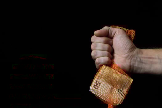 Hand holding cash on black background photo