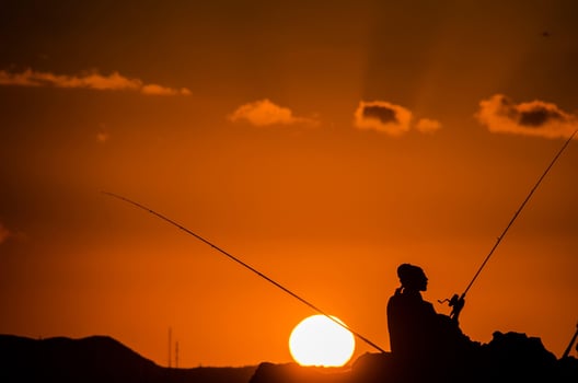 Fishing reel over the sunset photo