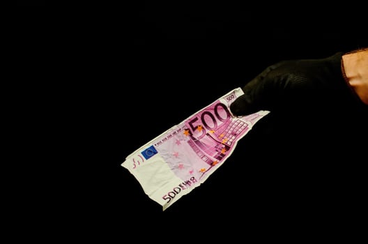 Hand holding cash on black background photo