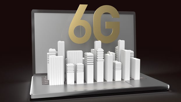 The 3d rendering 6g text gold surface glow on notebook and building  in dark image for mobile technology content. photo