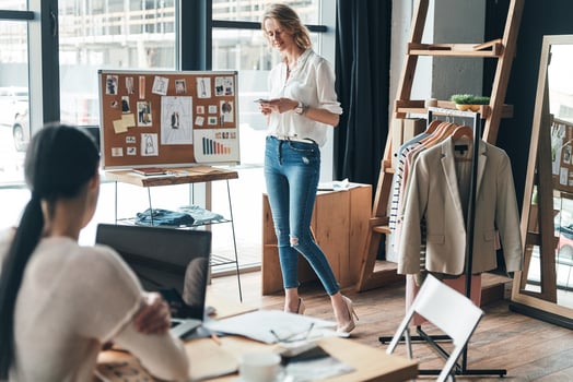 Good working day. Beautiful young woman typing a business message while working together with her partner in the workshop photo