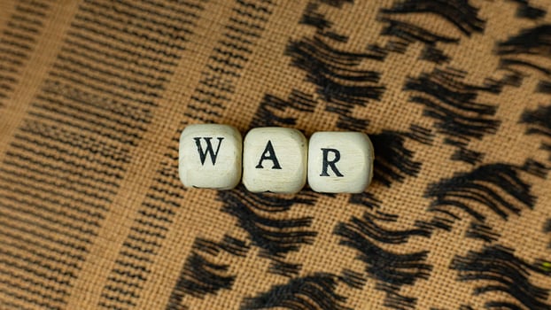 war on wood cube  on  shemagh  for  military content. photo