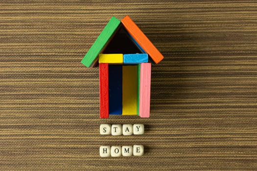 stay home on wood cube and home toy for social distancing content. photo