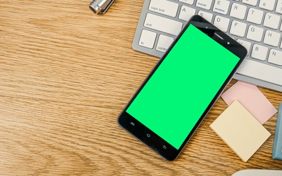The keyboard  and smart phone green screen on wood table for life style content. photo