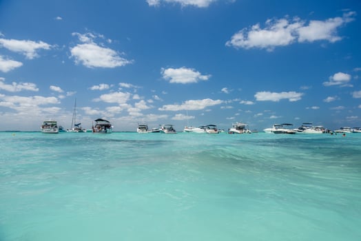 White speed boats and yachts in turquoise azure caribbean sea, Isla Mujeres island, Caribbean Sea, Cancun, Yucatan, Mexico photo