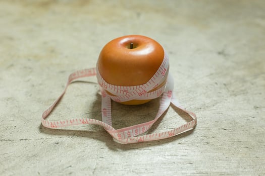 Apple and measuring tape image  for diet content. photo
