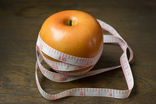 Apple and measuring tape image  for diet content. photo