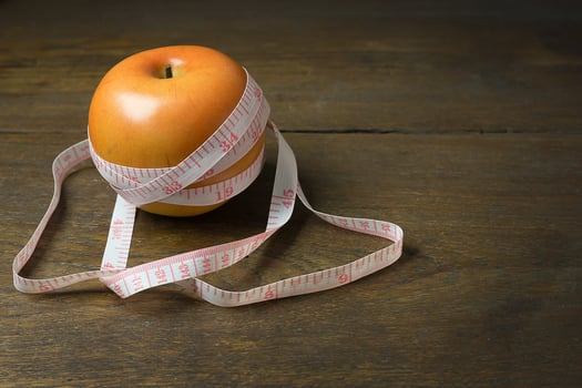 Apple and measuring tape image  for diet content. photo