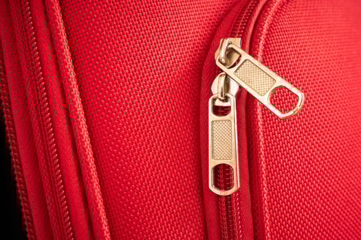 zip close-up on a tourist red suitcase photo