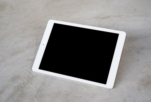 Tablet on cement floor photo