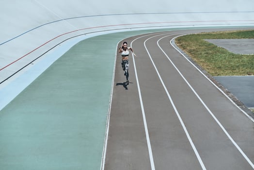 Her best speed. Full length top view of young woman in sports clothing jogging while exercising outdoors photo