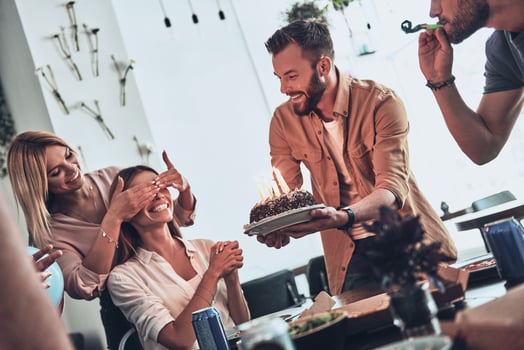 Our birthday girl. Group of happy people celebrating birthday among friends and smiling while enjoying a party photo