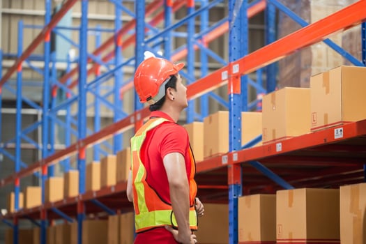 Warehouse worker checking inventory in warehouse, Forman worker working in factory warehouse photo