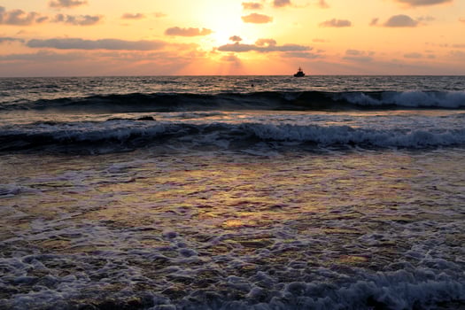 The sun sets below the horizon on the Mediterranean Sea in northern Israel. photo
