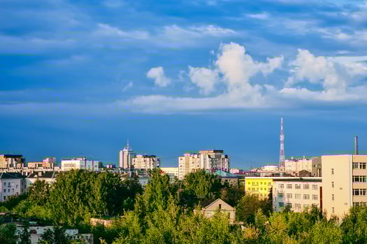 Aerial view of suburbs. Residential buildings in sun against blue sky. photo
