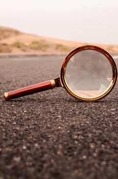 Magnifying glass on the road photo