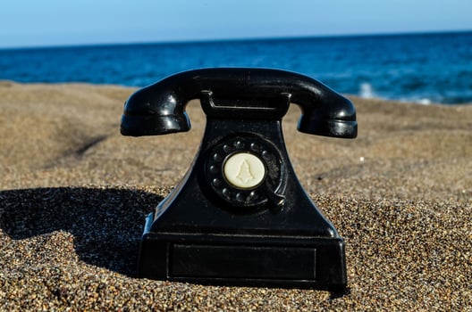 Old telephone on the beach photo