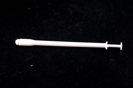Syringe on dark background photo