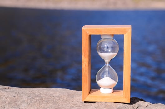 Hourglass on a rock photo
