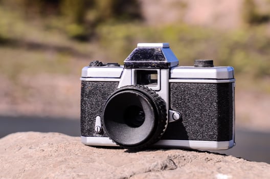 Vintage camera by the ocean photo