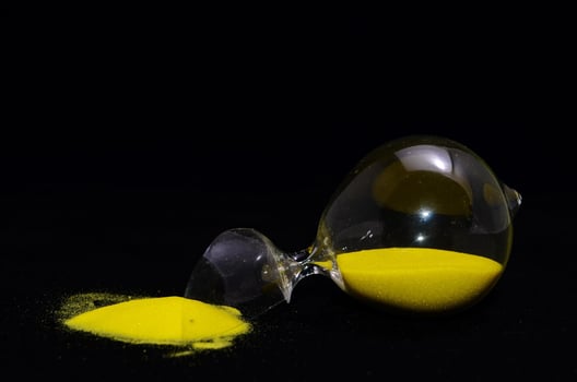 Hourglass on black background photo