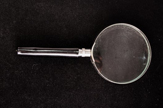 Magnifying glass on black background photo