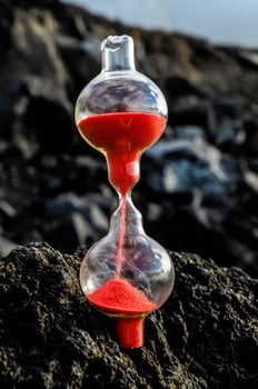 Red hourglass on the rocks photo
