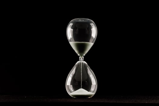 Hourglass isolated on black photo