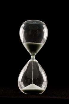 Hourglass on black background photo