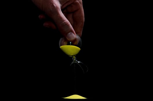 Hourglass on dark background photo