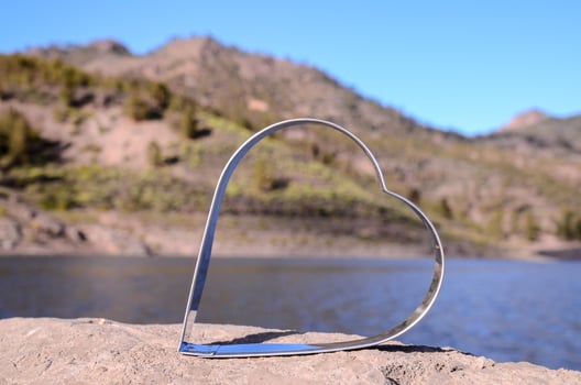 Metal heart on a rock photo