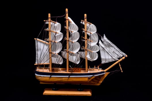 Wooden ship on dark background photo