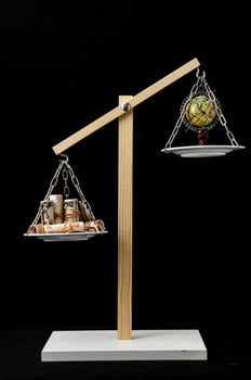 Scale weighing money and globe photo