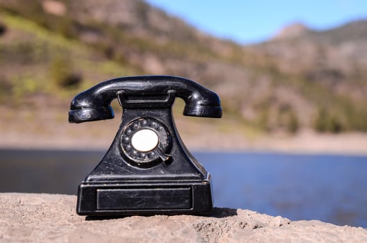 Vintage telephone on a rock photo